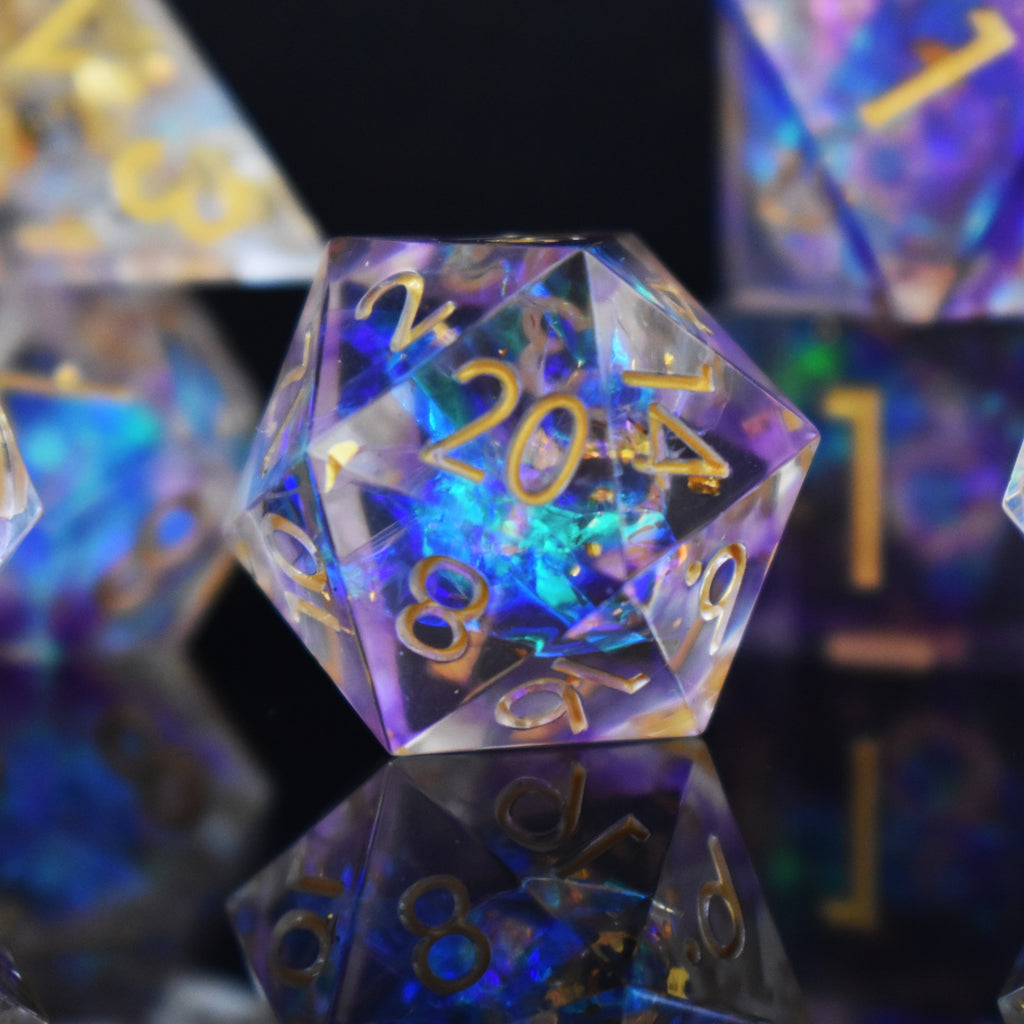 A set of clear sharp edge resin dnd dice with gold numbering and pastel neon iridescent foil inside for tabletop games and board games