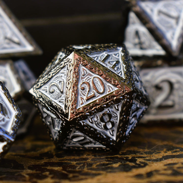 A set of white and gunmetal gray metal dice with musical note details around the gunmetal grey numbers on a wooden surface, including various shapes such as a d4, d6, d8, d10, d12, and d20.
