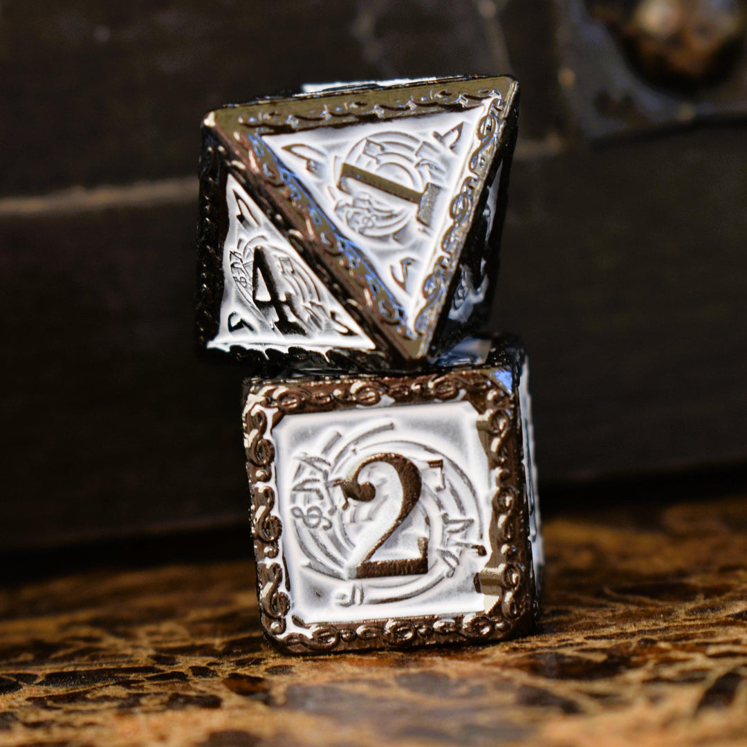 A set of white and gunmetal gray metal dice with musical note details around the gunmetal grey numbers on a wooden surface, including various shapes such as a d4, d6, d8, d10, d12, and d20.