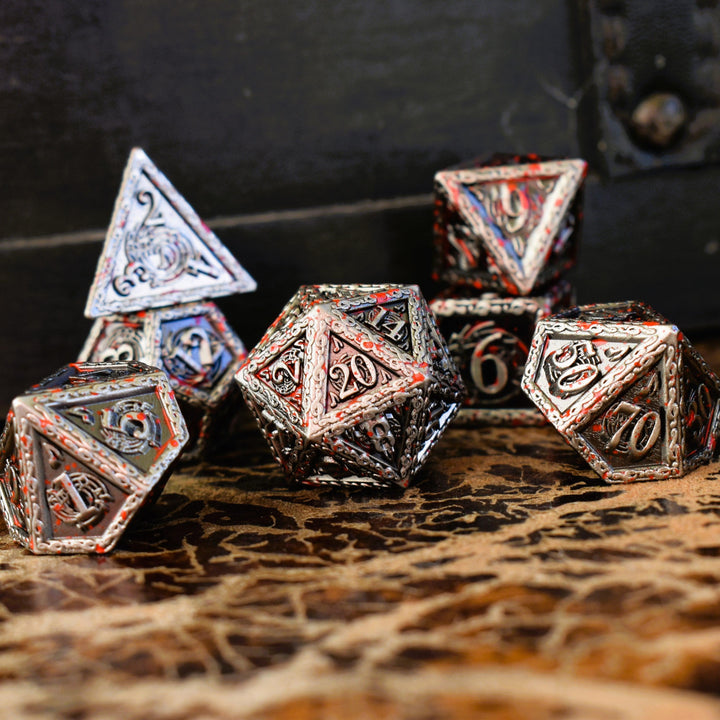 A set of silver metal dice with musical note details around the silver numbers splattered in red blood on a wooden surface, including various shapes such as a d4, d6, d8, d10, d12, and d20.