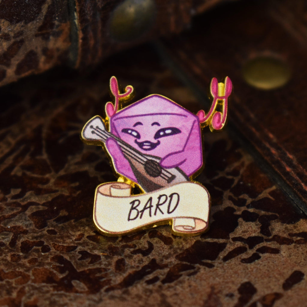 A colorful enamel pin depicting a character with a guitar and a scroll labeled 'BARD'.