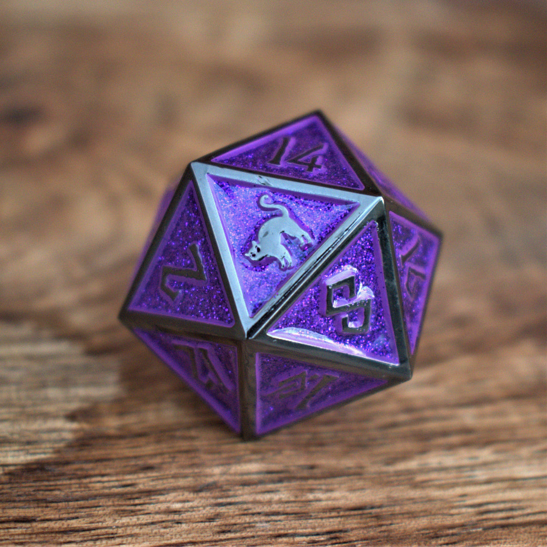A large purple metal d20 die with gunmetal grey borders and numbers and a black cat on the d20 face for tabletop gaming wargaming and board games