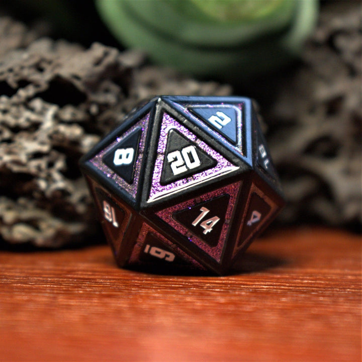 A set of black metal dice with purple glitter borders on each face and white numbering for wargaming tabletop gaming and board games