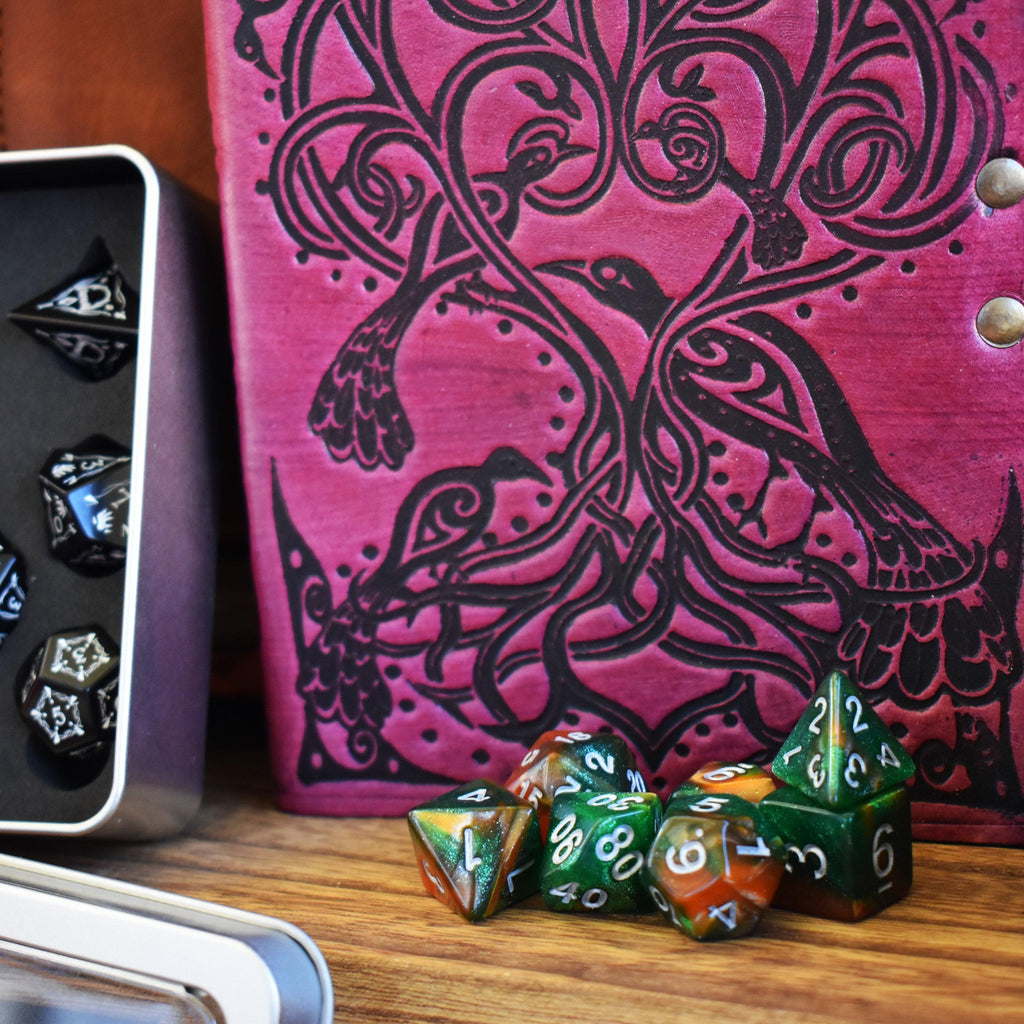 A dice set and leather journal, examples of items within the mystery bundle