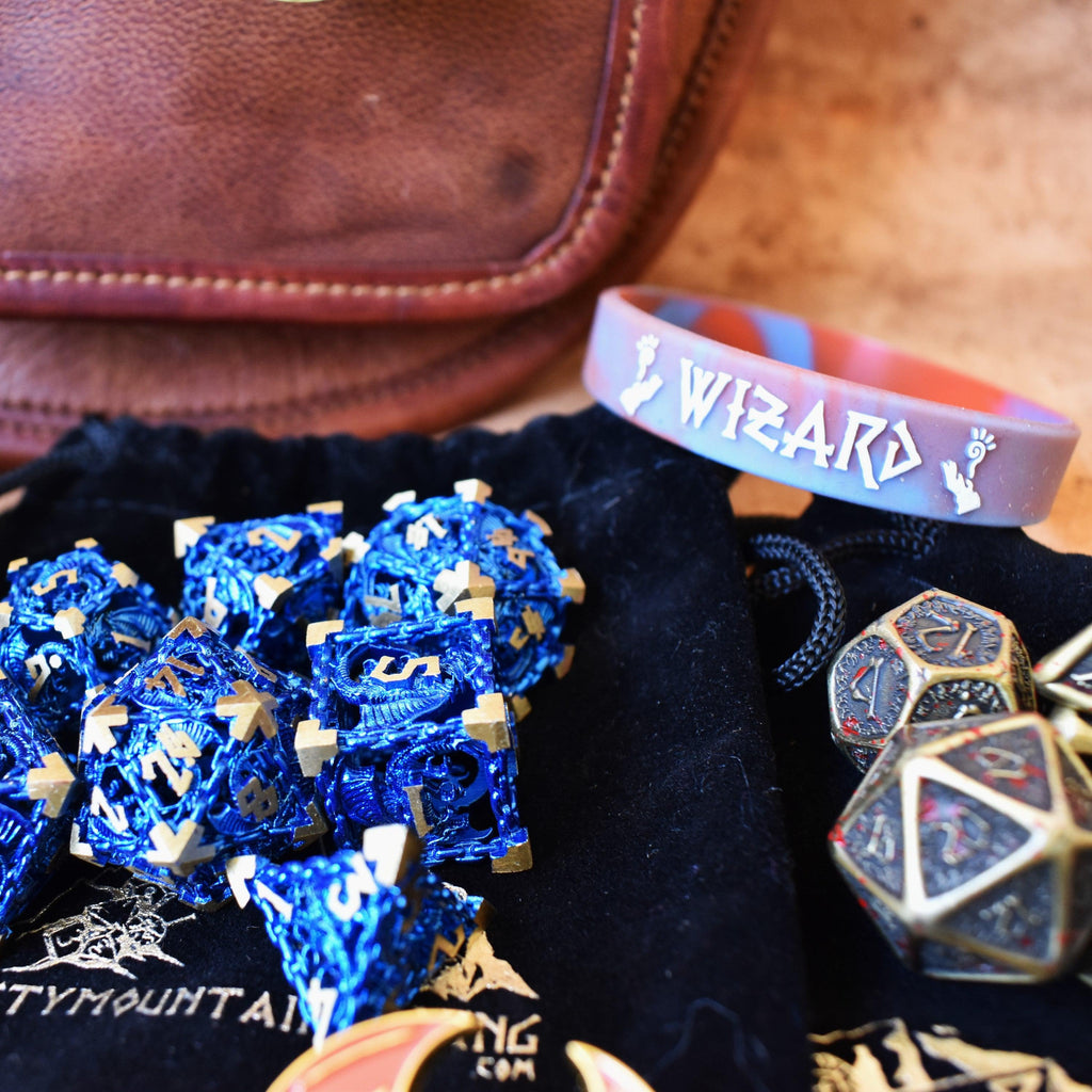 2 sets of dice and a bracelet showing examples of what come in our mystery bundle