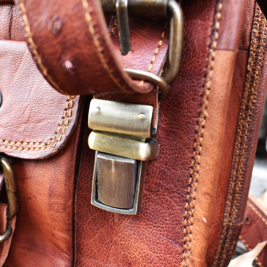 Up close photo of clasp on brown leather bag