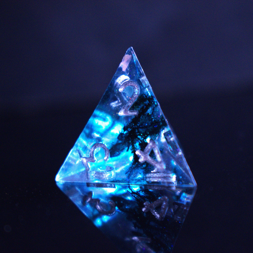 A set of sharp-edged resin dnd dice in blue with silver numbers and black and glitter details inside for ttrpg and board games