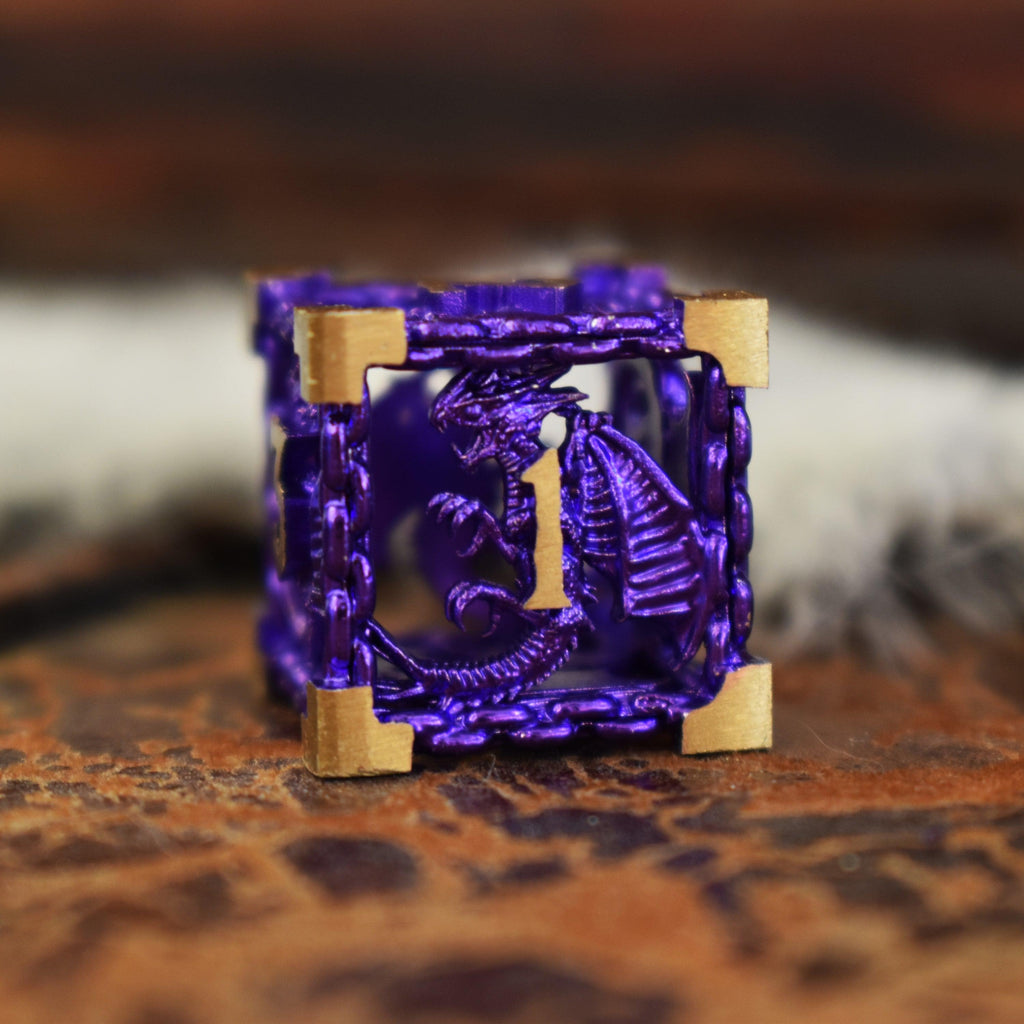 A set of purple hollow metal dice with gold embossed numbers, including various shapes such as a D4, D6, D8, D10, D12, and D20, displayed on a wooden surface.