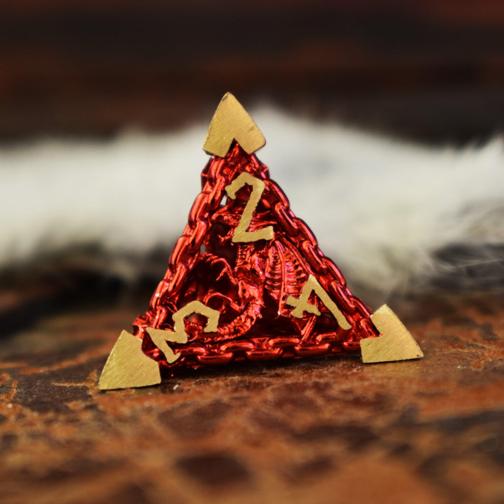 A set of red hollow metal dice with embossed numbers, displayed on a textured surface.
