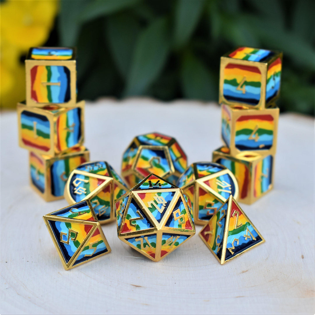 a set of rainbow metal dnd dice with gold borders and numbers on a wooden surface for wargaming tabletop gaming and board games