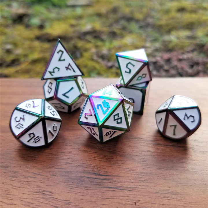 A set of white and iridescent metal dice with embossed numbers, displayed on a wooden surface.