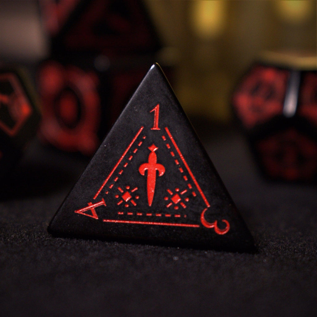 A set of black Obsidian gemstone dice with red engraved numbers and symbols, including a D4, D6, D8, two D10s, D12, and D20, displayed on a dark surface with a blurred light background.