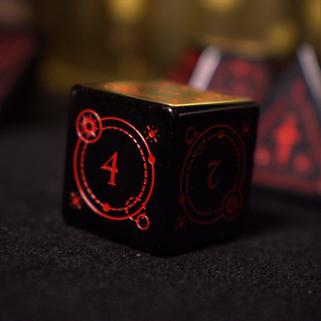 A set of black Obsidian gemstone dice with red engraved numbers and symbols, including a D4, D6, D8, two D10s, D12, and D20, displayed on a dark surface with a blurred light background.