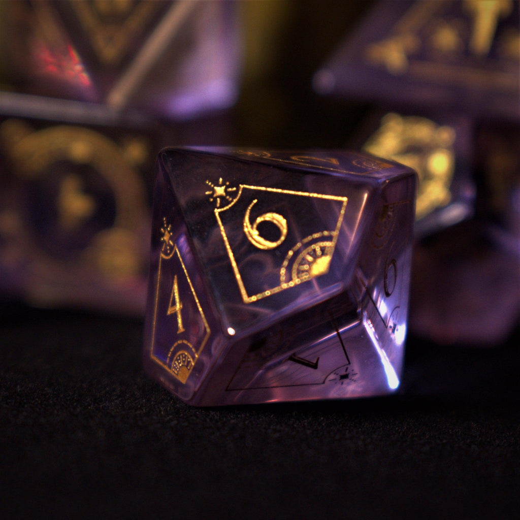 A set of purple glass dice with engraved golden numbers and detail, displayed on a dark surface with a light source in the background creating a reflective sheen on the dice.