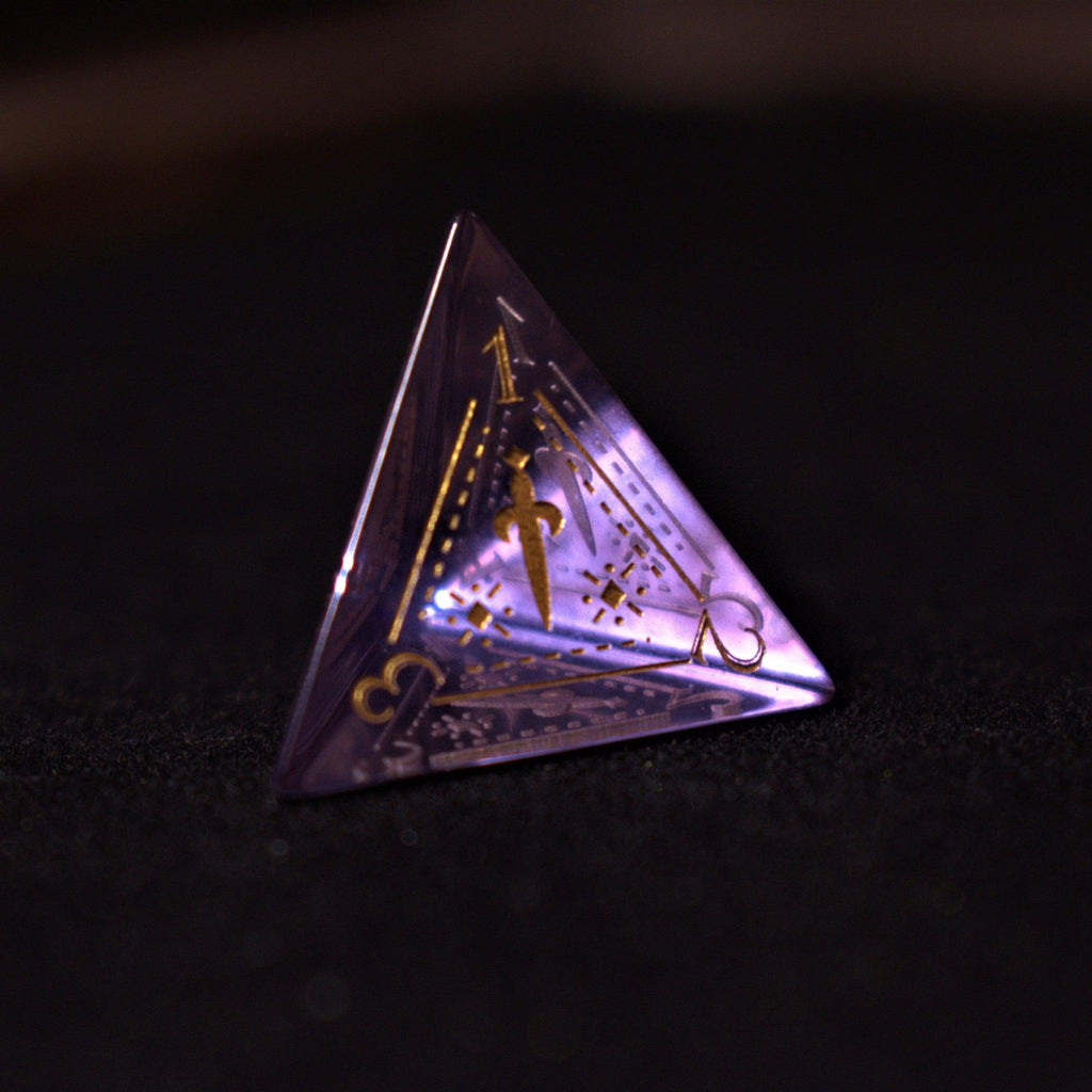 A set of purple glass dice with engraved golden numbers and detail, displayed on a dark surface with a light source in the background creating a reflective sheen on the dice.