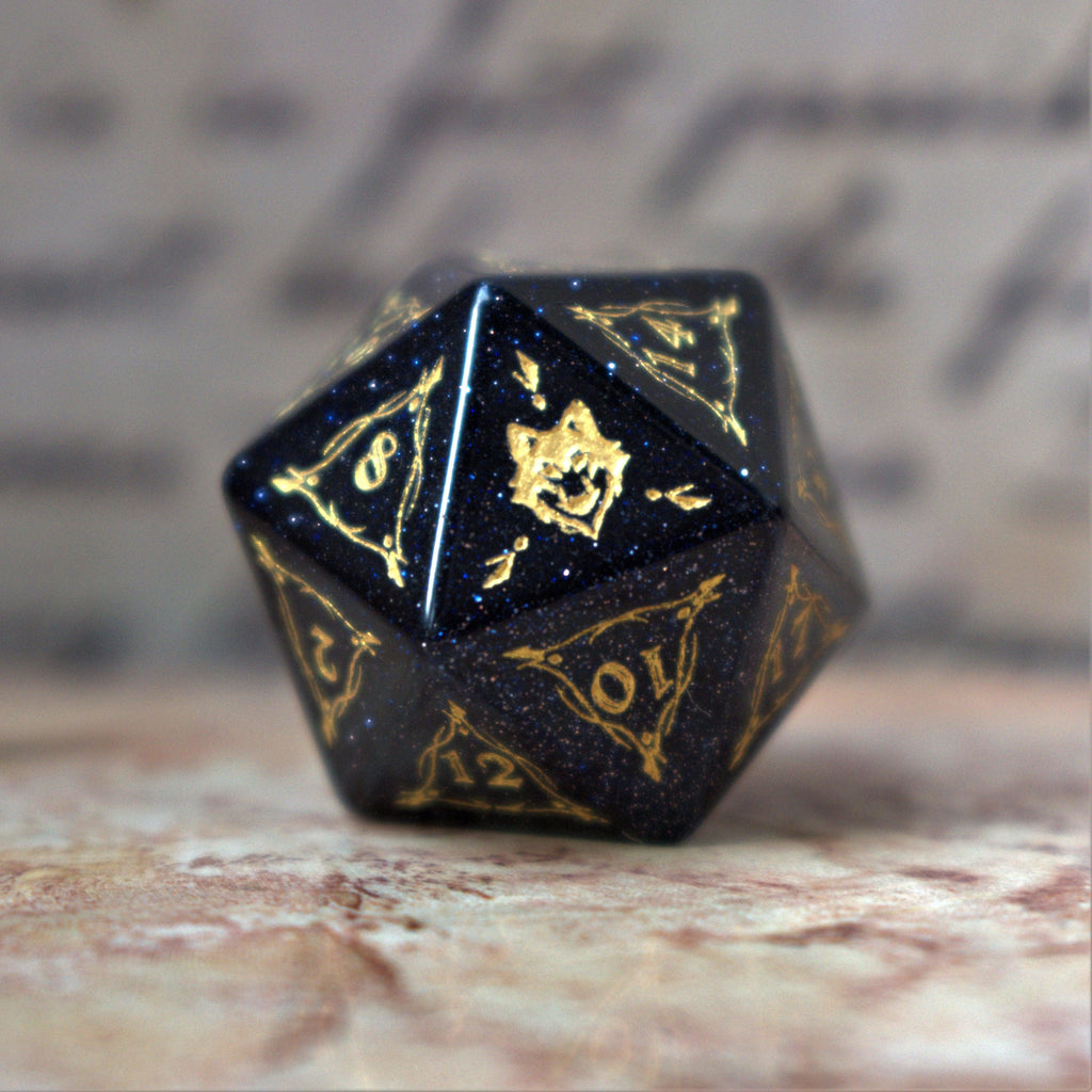 A set of Fangs of Winter Blue Sandstone Stone Dice with gold engravings on a textured background.