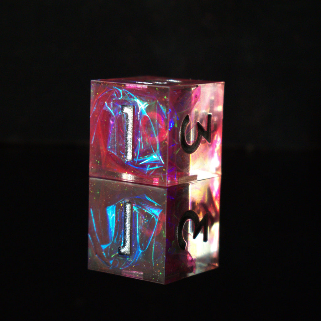 A set of sharp-edged, pink resin dnd dice with silver engraved numbers, reflecting a metallic sheen inside of each die