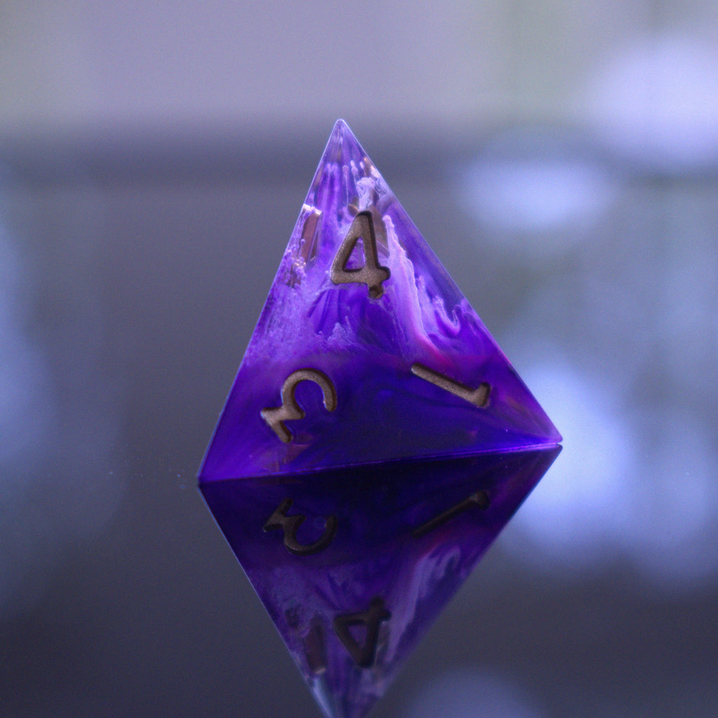 A set of sharp-edged, purple resin dice with engraved numbers, including various shapes such as a d4, d6, d8, d10, d12, and d20.
