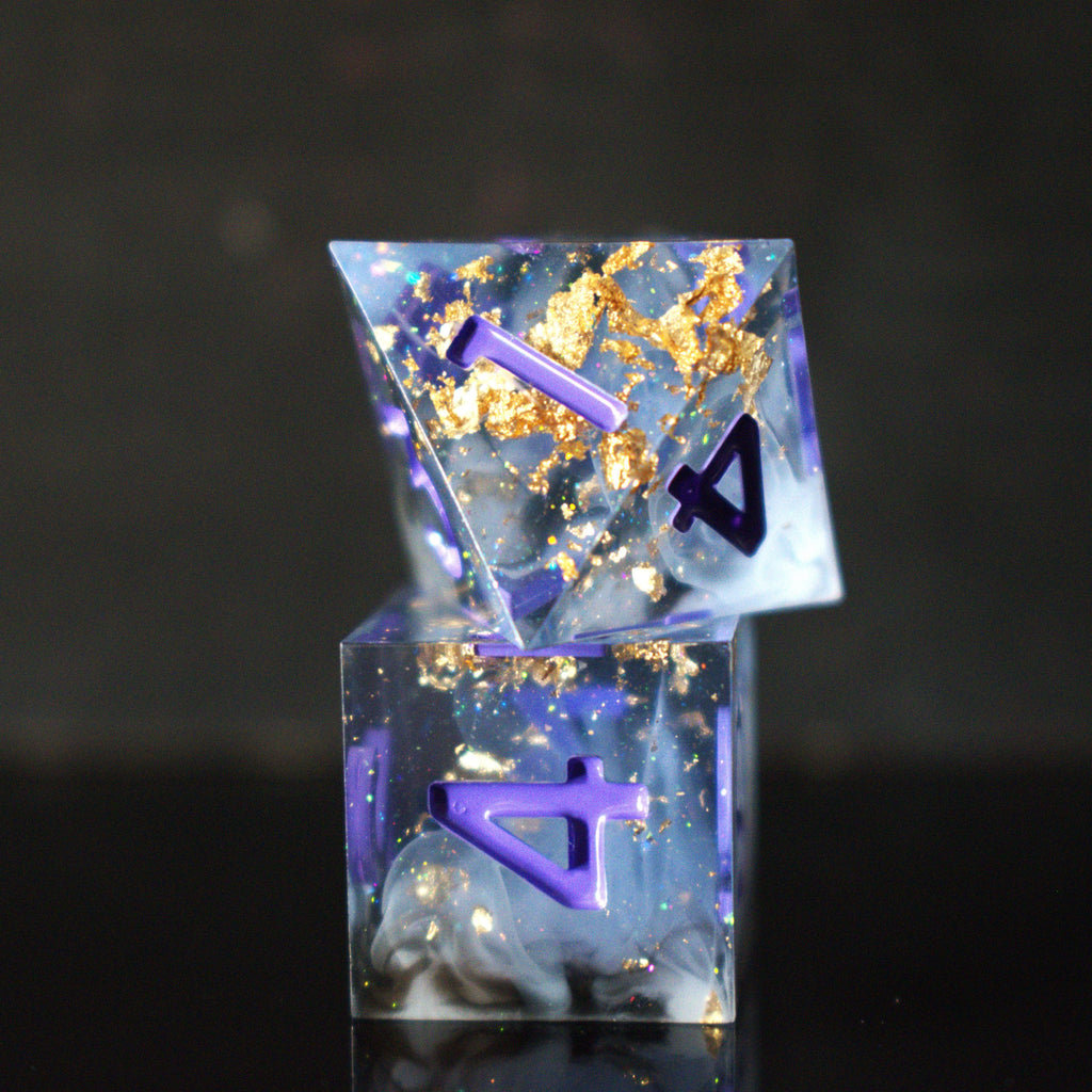 A clear, glittery sharp edge resin dnd dice set with cloudy white and black running through them and purple numbering for tabletop gaming