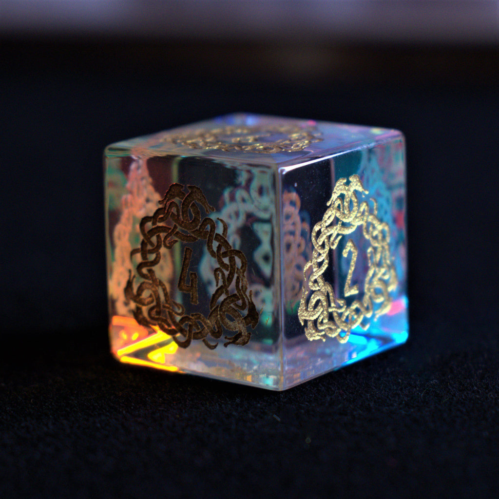 A set of hand-carved, iridescent prism glass dnd dice with engraved numbers, including a D4, D6, D8, two D10s, D12, and D20.