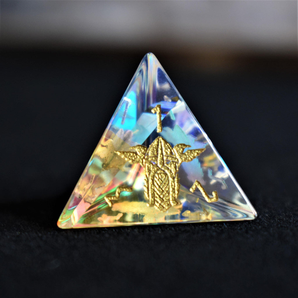 A set of hand-carved, iridescent prism glass dnd dice with engraved numbers, including a D4, D6, D8, two D10s, D12, and D20.