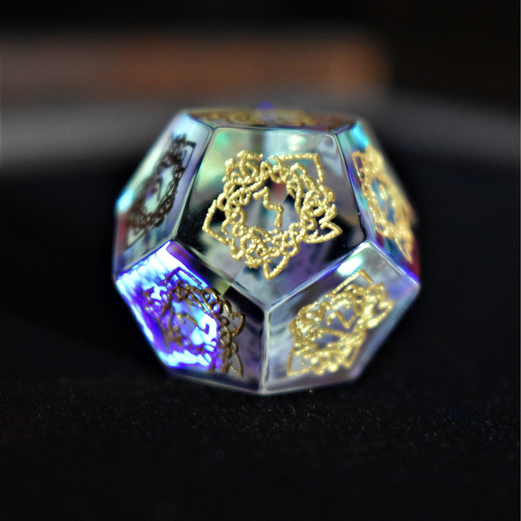 A set of hand-carved, iridescent prism glass dnd dice with engraved numbers, including a D4, D6, D8, two D10s, D12, and D20.