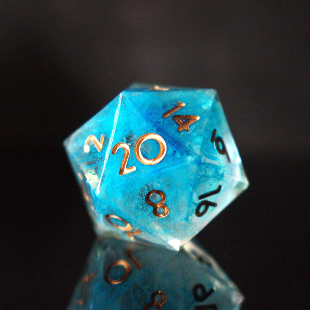 A set of sharp-edged resin dice in blue with gold numbers, including various shapes typical for RPG games.