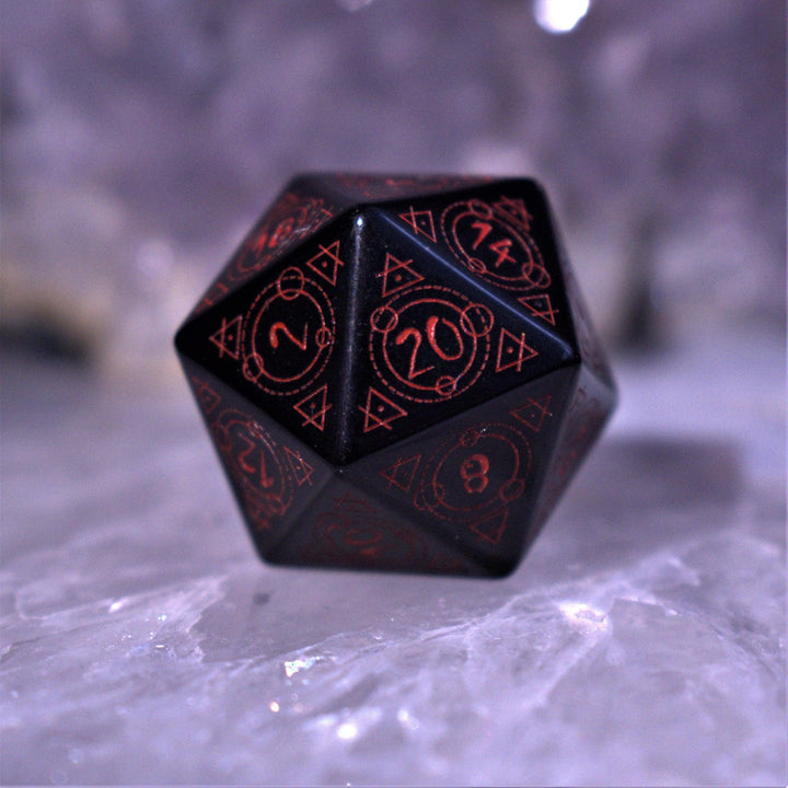 A set of Spellcaster Obsidian Stone polyhedral Dice with red engraved numbers and symbols