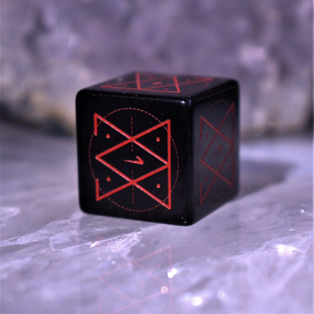 A set of Spellcaster Obsidian Stone polyhedral Dice with red engraved numbers and symbols