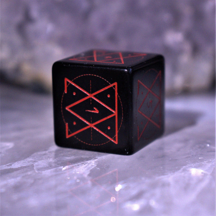 A set of Spellcaster Obsidian Stone polyhedral Dice with red engraved numbers and symbols