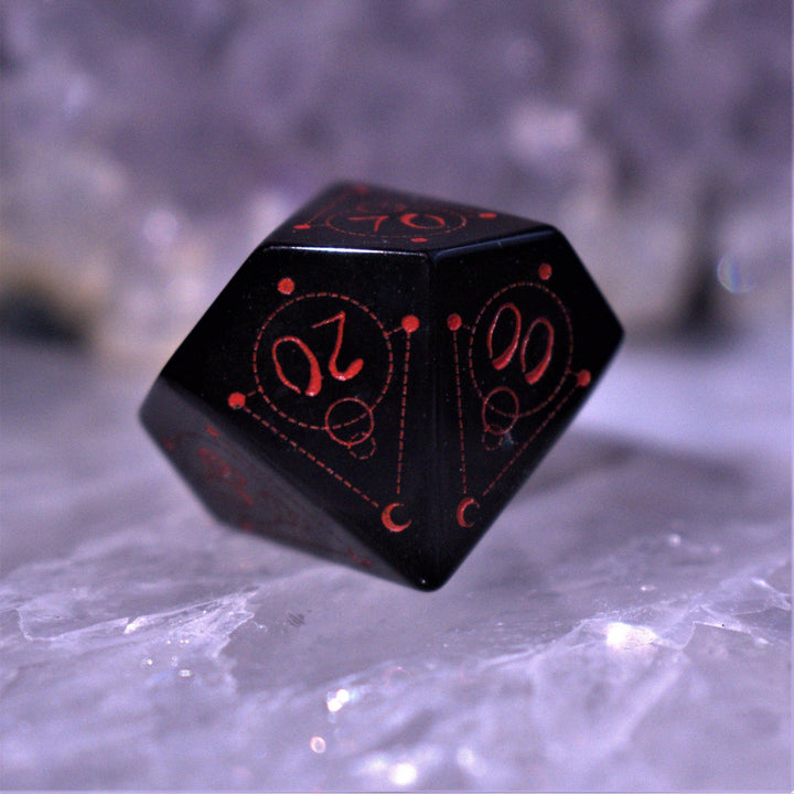 A set of Spellcaster Obsidian Stone polyhedral Dice with red engraved numbers and symbols