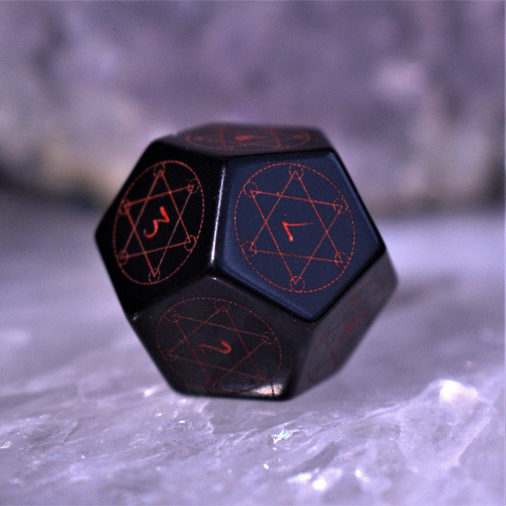 A set of Spellcaster Obsidian Stone polyhedral Dice with red engraved numbers and symbols