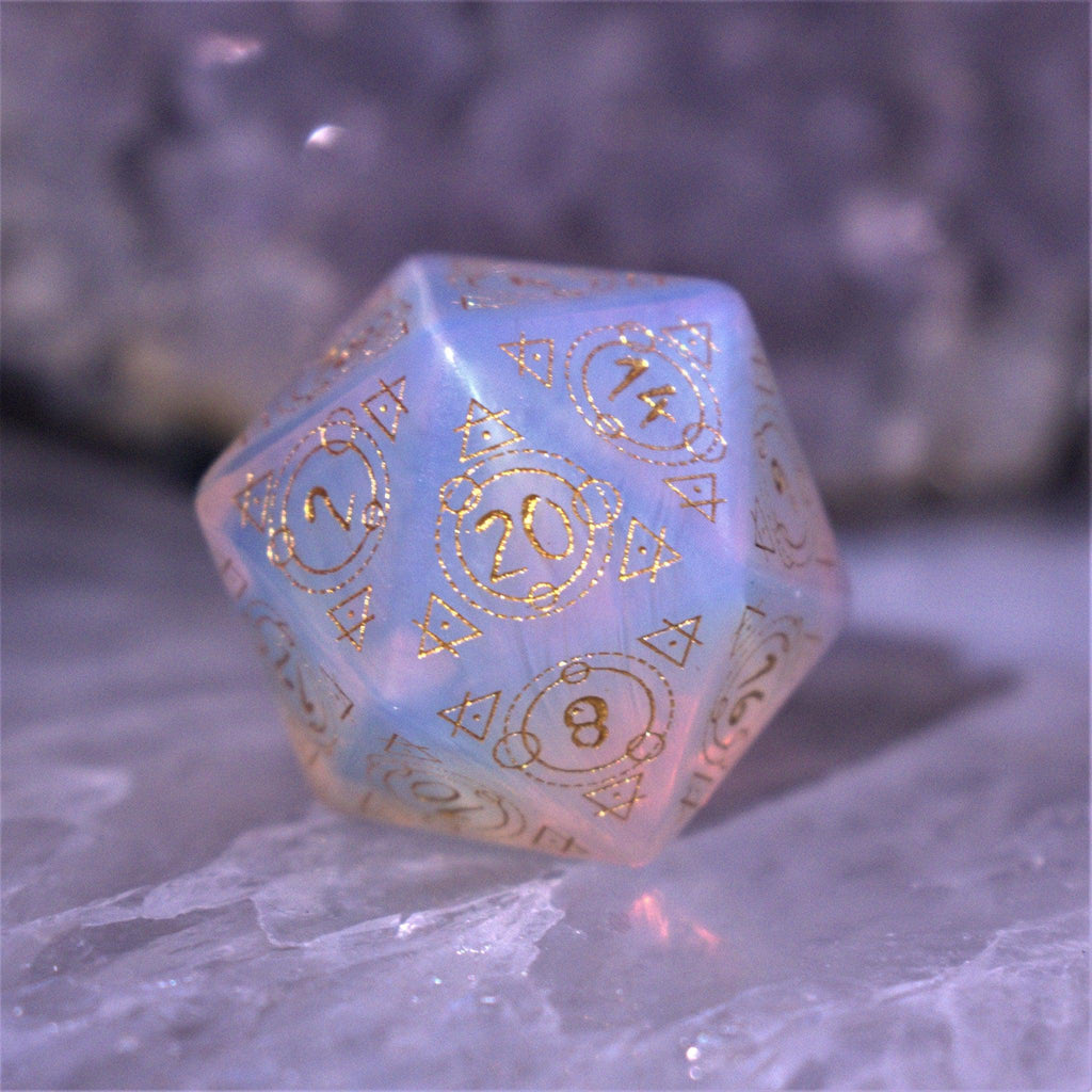 A set of hand-carved, Opalite gemstone dnd dice with engraved and golden hand-painted designs to create an iridescent spellcasting experience  