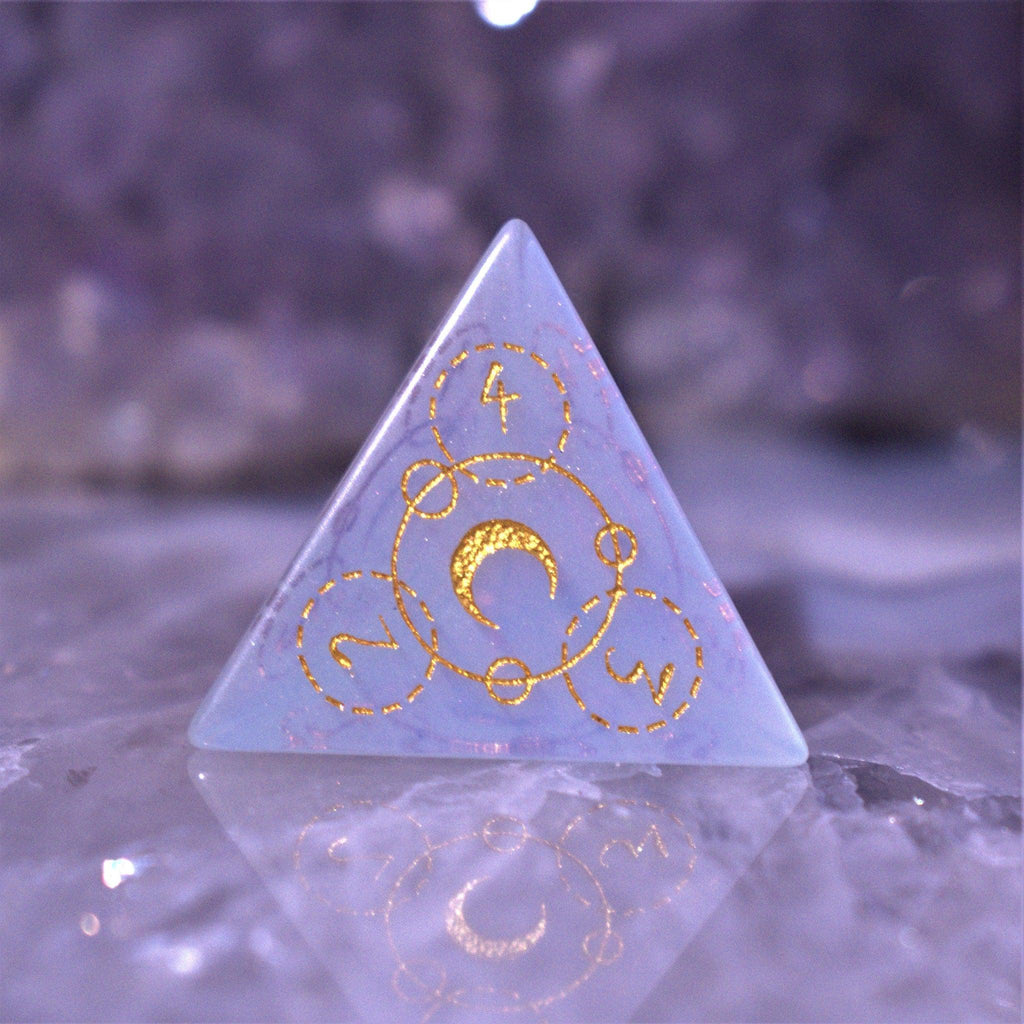 A set of hand-carved, Opalite gemstone dnd dice with engraved and golden hand-painted designs to create an iridescent spellcasting experience  