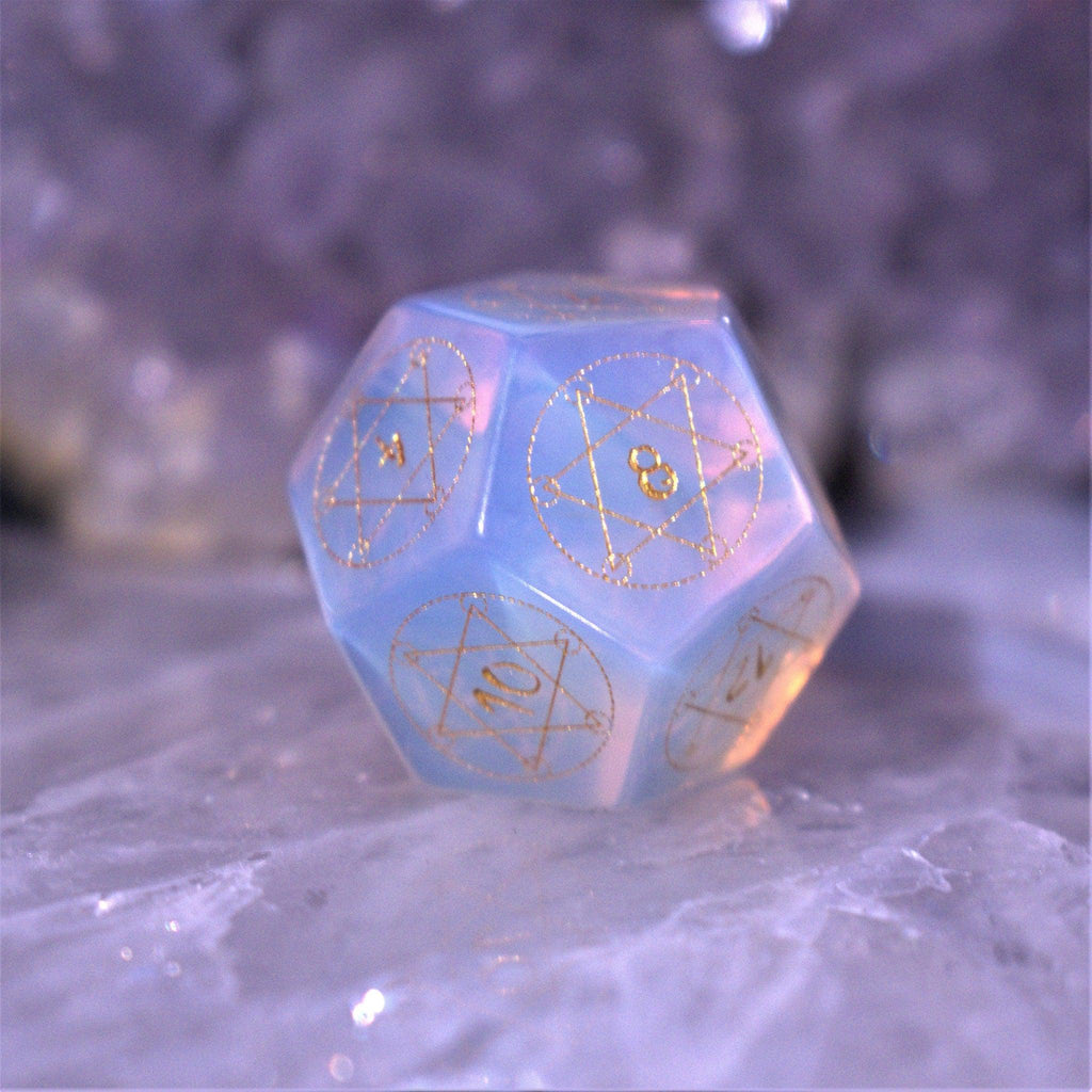A set of hand-carved, Opalite gemstone dnd dice with engraved and golden hand-painted designs to create an iridescent spellcasting experience  