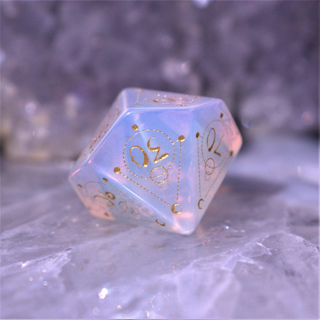 A set of hand-carved, Opalite gemstone dnd dice with engraved and golden hand-painted designs to create an iridescent spellcasting experience  