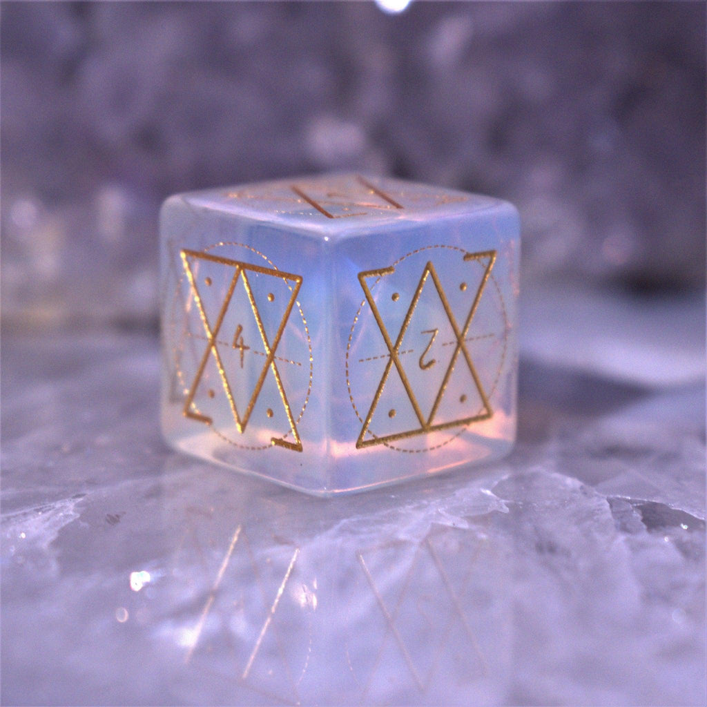 A set of hand-carved, Opalite gemstone dnd dice with engraved and golden hand-painted designs to create an iridescent spellcasting experience  