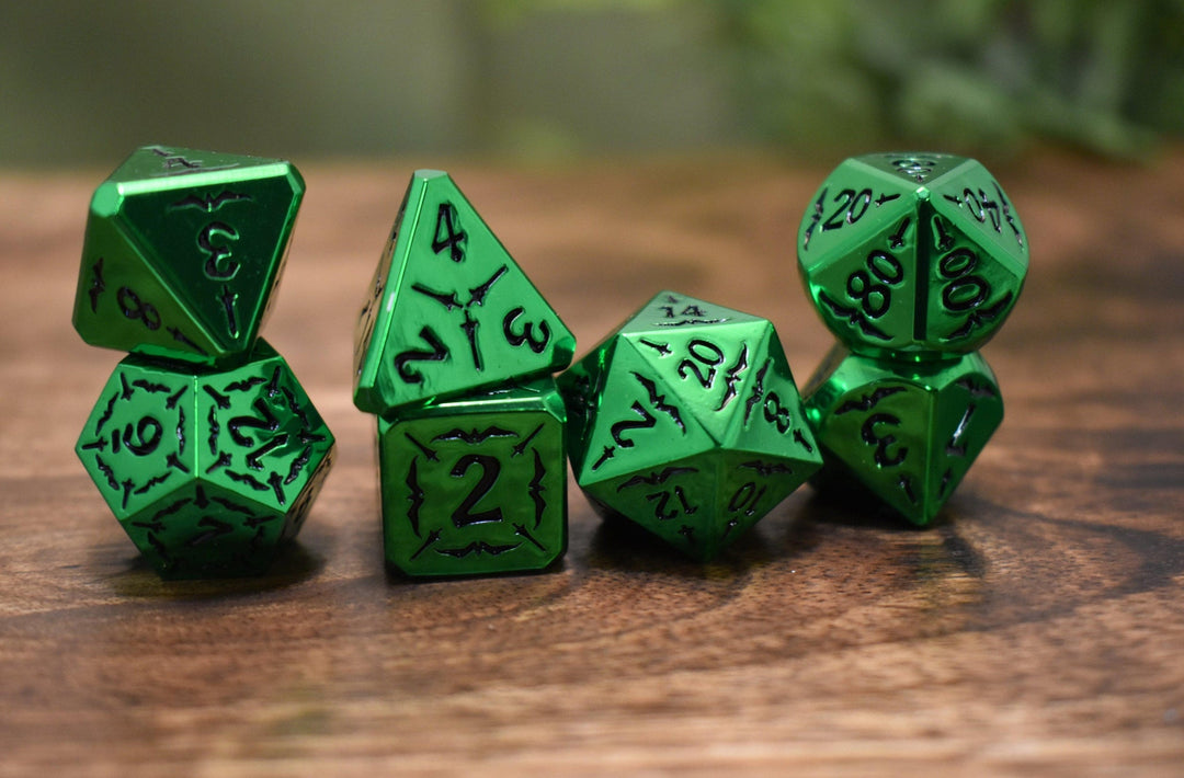 A set of solid metal green metallic dnd polyhedral dice with black numbering and sword details for tabletop gaming and board games