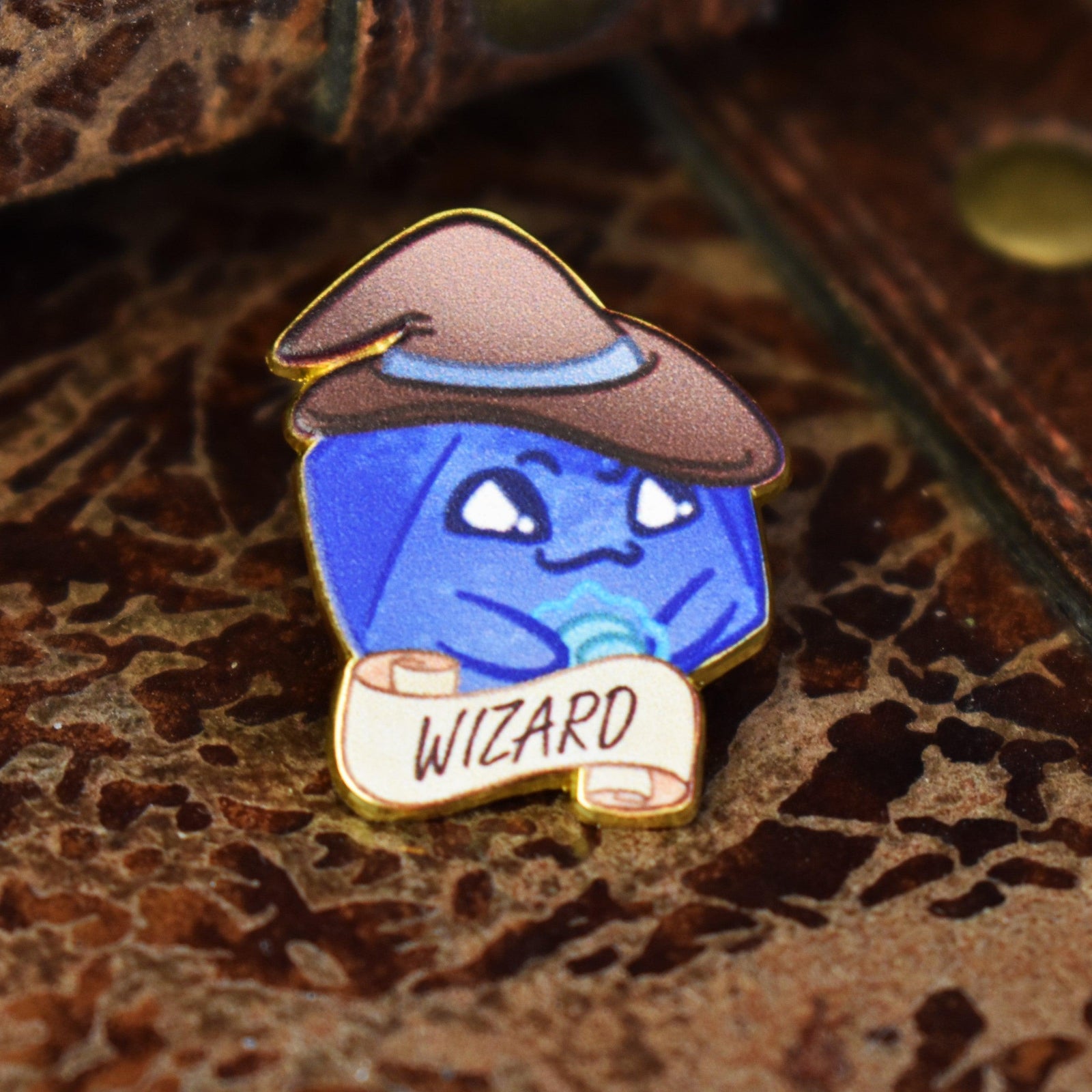 Cartoon blue d20 shaped character wearing a red wizard hat with a 'Wizard' label on a dark background