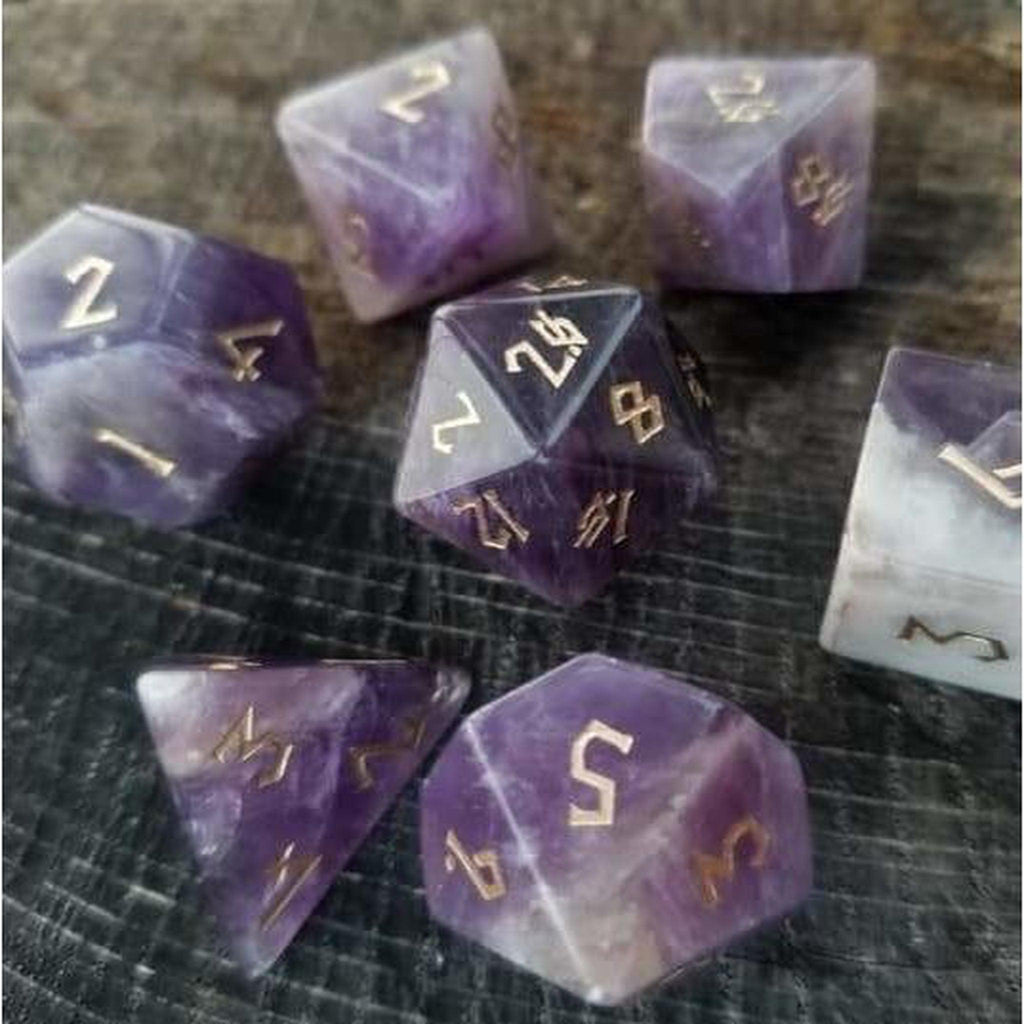 An amethyst stone dice set featuring gold numbers in a Nordic font