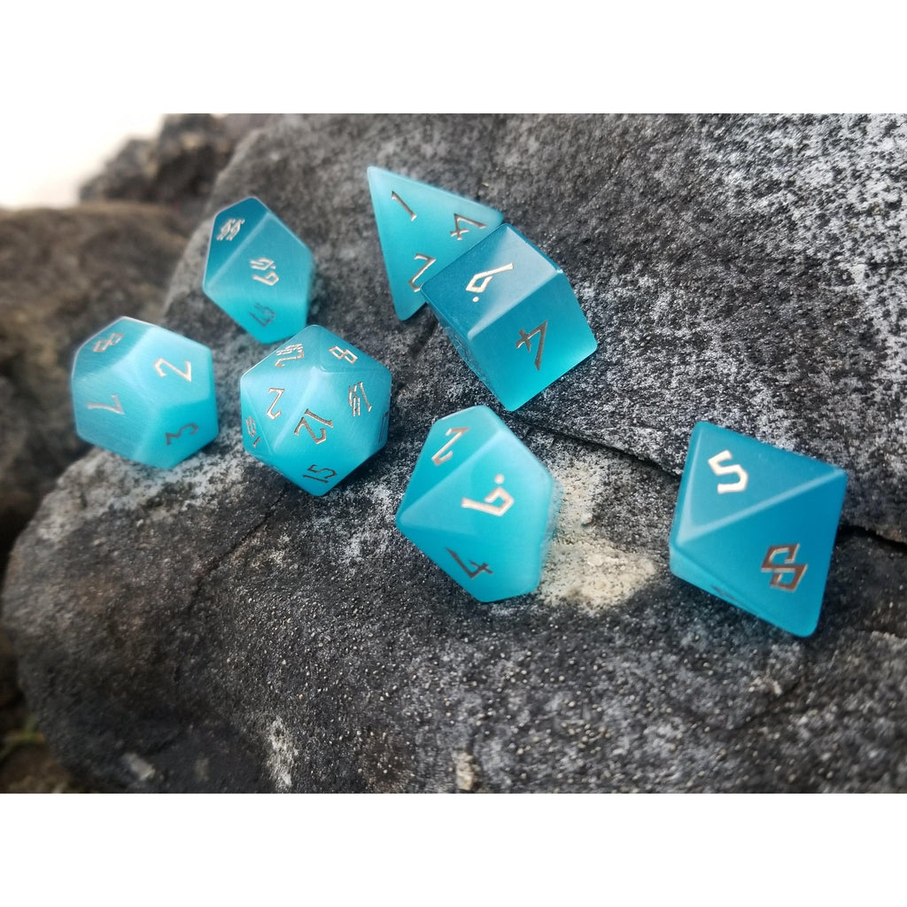 Blue cats eye dice set with gold numbers in a Nordic font
