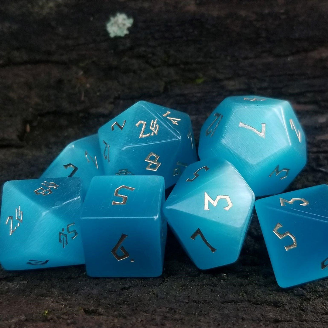Blue cats eye dice set with gold numbers in a Nordic font
