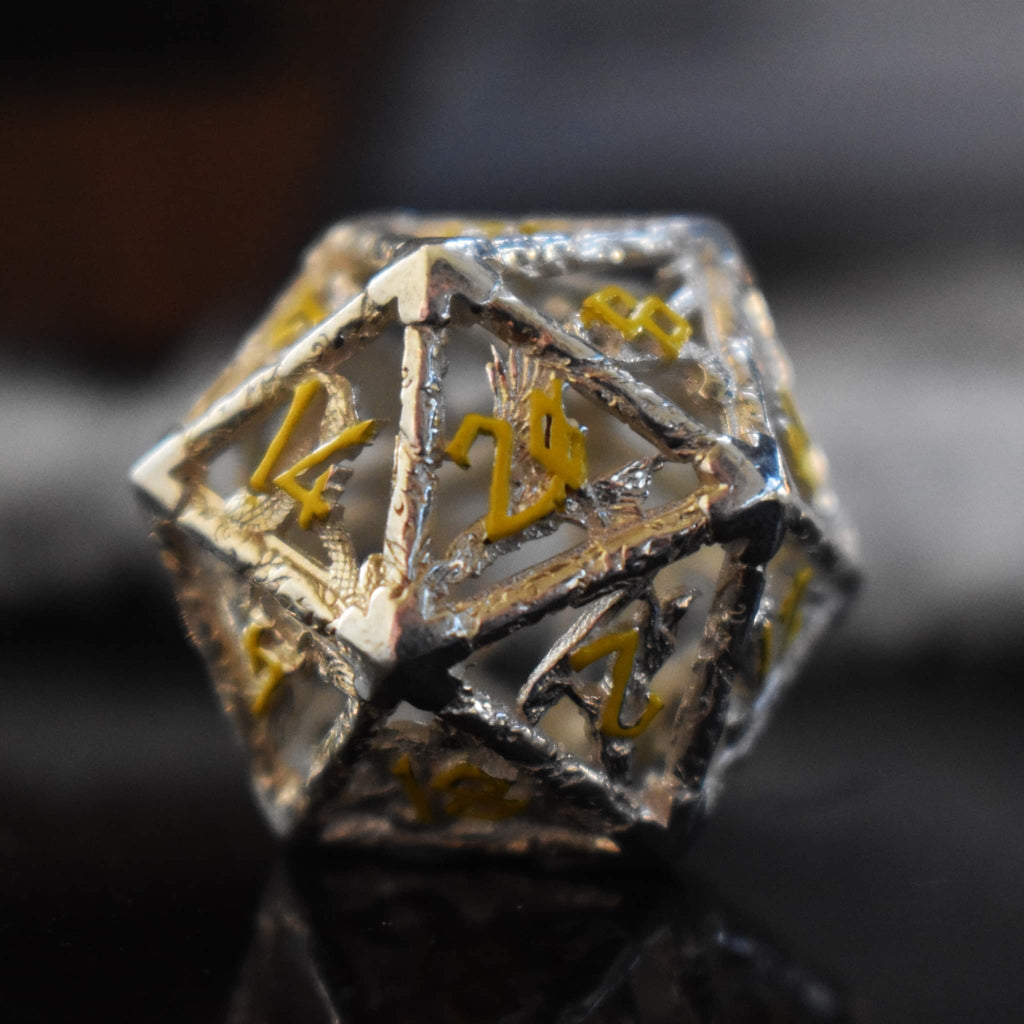 A hollow sterling silver D20 featuring yellow numbers in a Nordic font