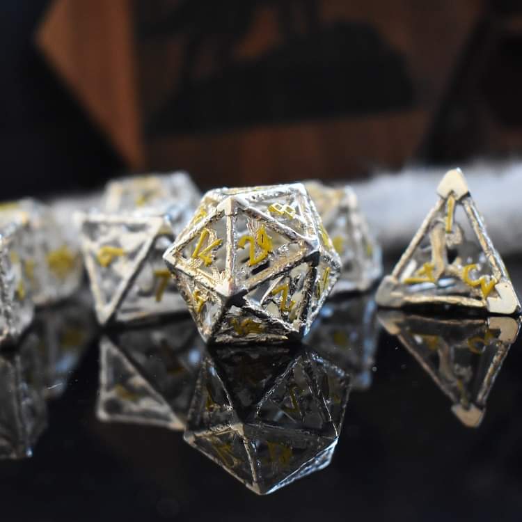 A hollow sterling silver dice set with yellow Nordic font numbers