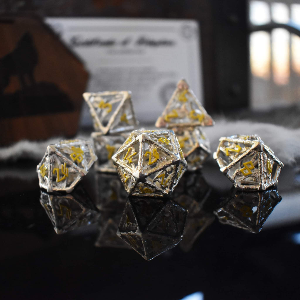 A hollow sterling silver dice set with yellow Nordic font numbers
